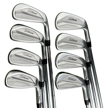 Mega Golf: Set of 8 Titleist 620 CB forged irons (3-Pw) with steel shafts and Golf Pride grips on grass.