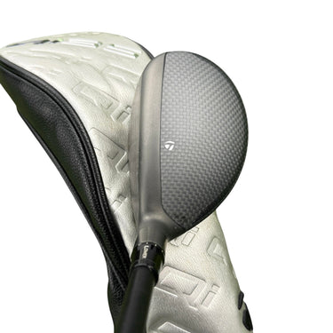 Mega Golf Taylormade Qi35 hybrid golf club with Ventus Blue graphite shaft and headcover on grass.