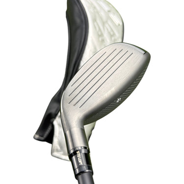 Mega Golf Taylormade Qi35 hybrid golf club with Ventus Blue graphite shaft and headcover on grass.