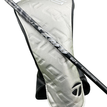 Mega Golf Taylormade Qi35 LS driver shaft with Kai'li Dark Waves White 60 Stiff flex and headcover on grass.
